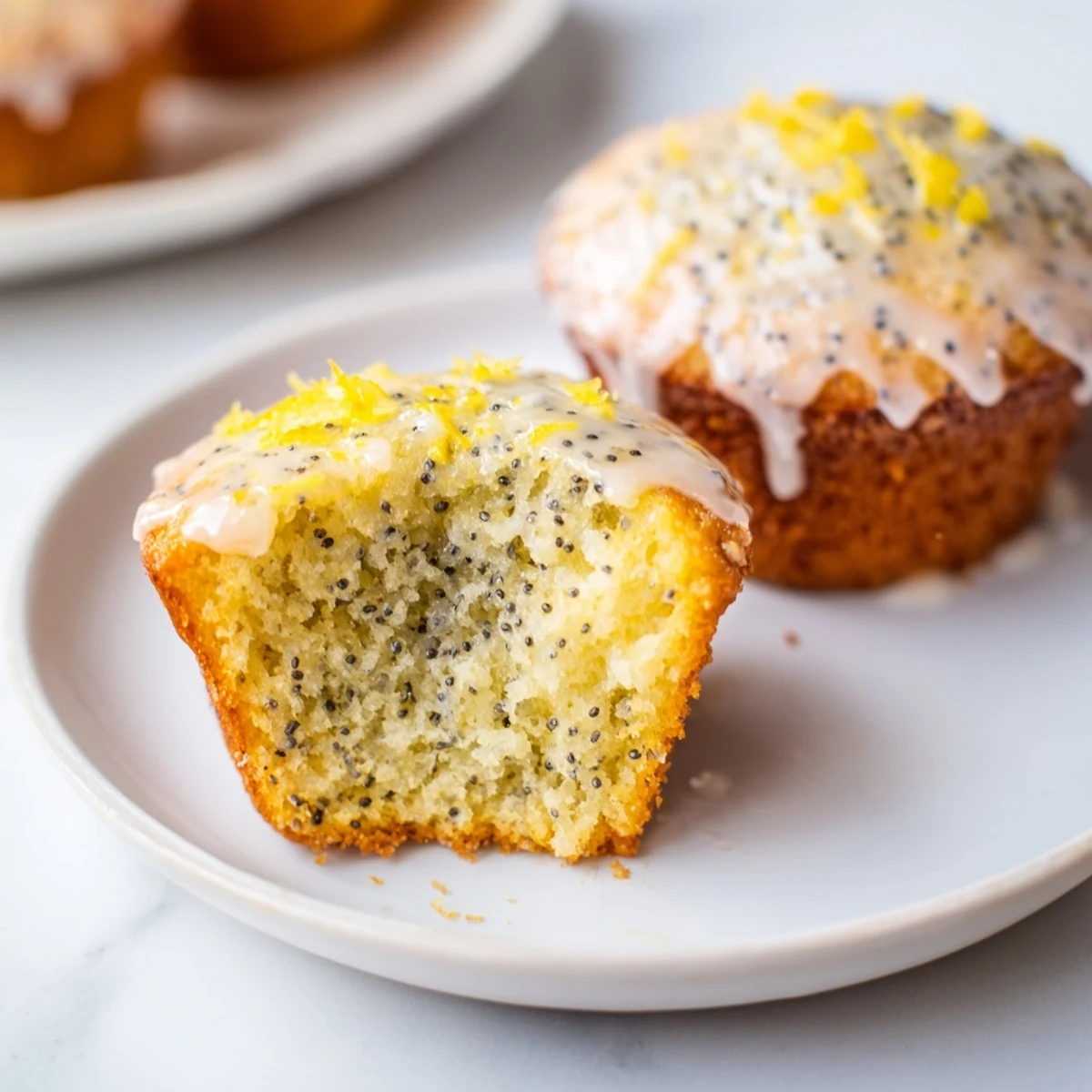 Golden-brown Lemon Poppy Seed Muffins, glazed beautifully, a perfect bakery-style treat with a zesty flavor.
