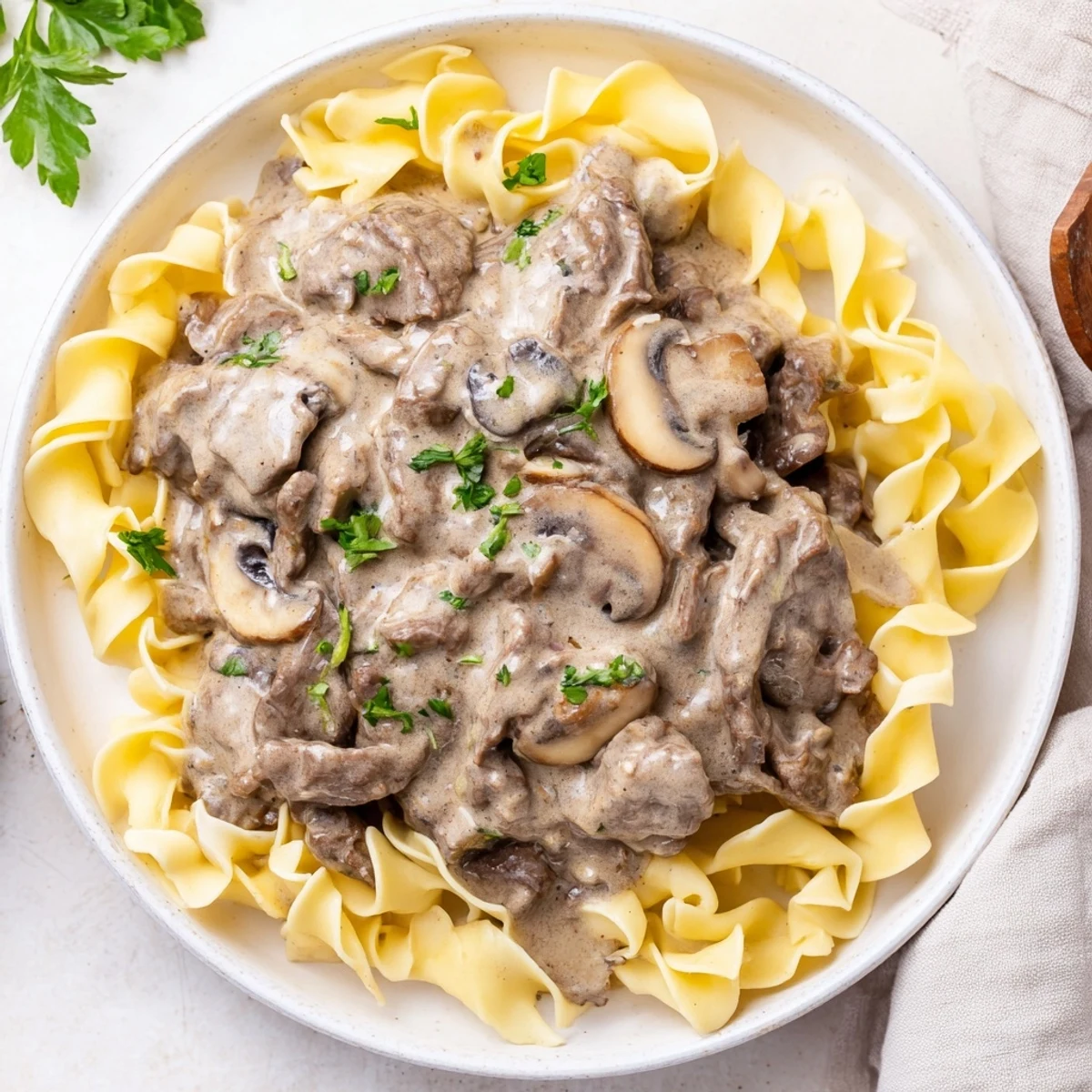 This close-up shows steaming beef stroganoff, a classic comfort food ready to eat for dinner.