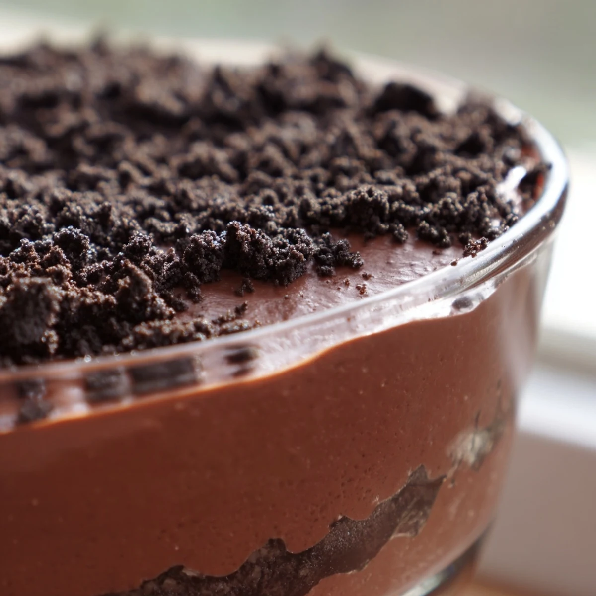 Chocolate Pudding Parfait topped with whipped cream and shaved chocolate, served chilled.