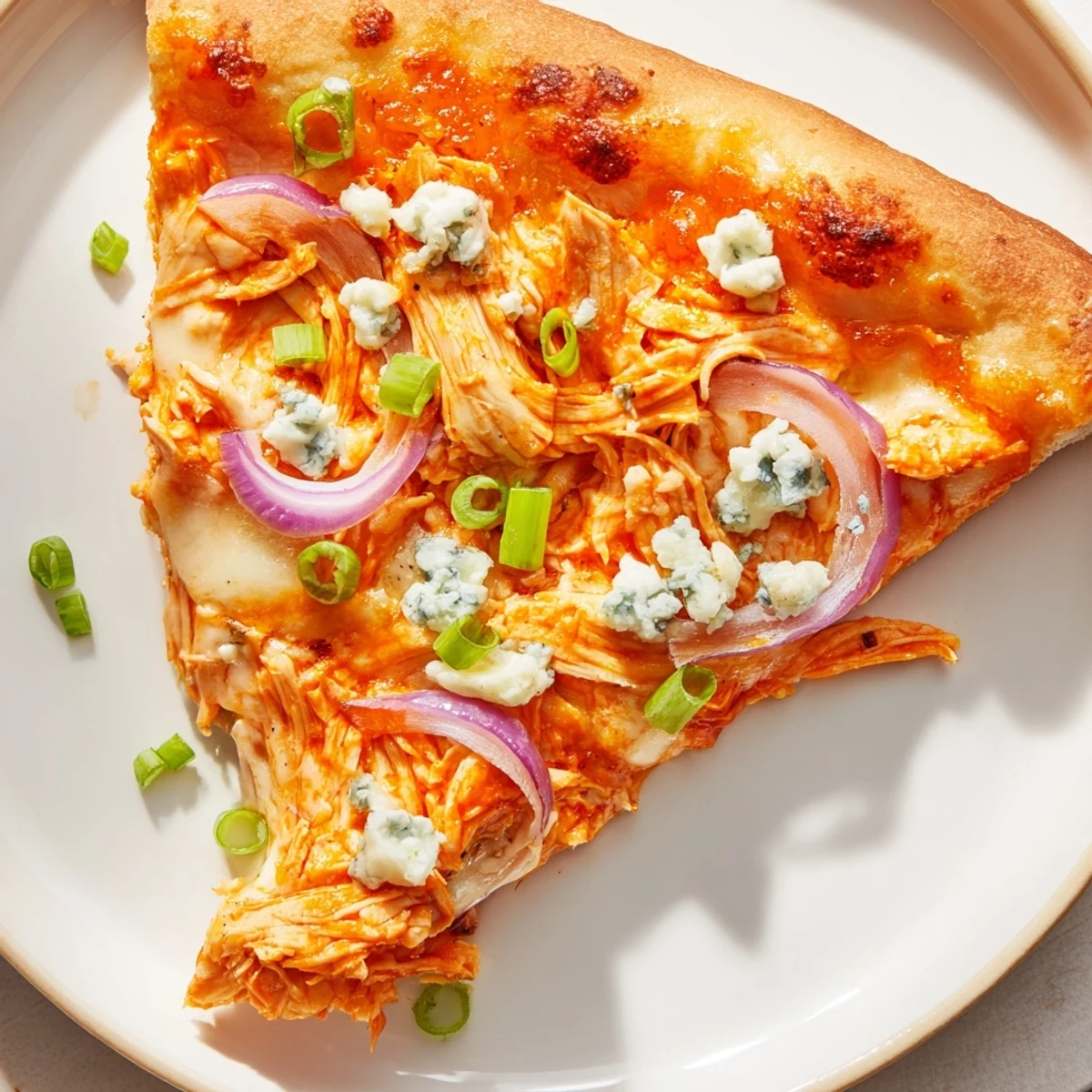 Fresh-baked MVP Buffalo Chicken Pizza with spicy chicken, tangy blue cheese, and melty mozzarella, served hot.