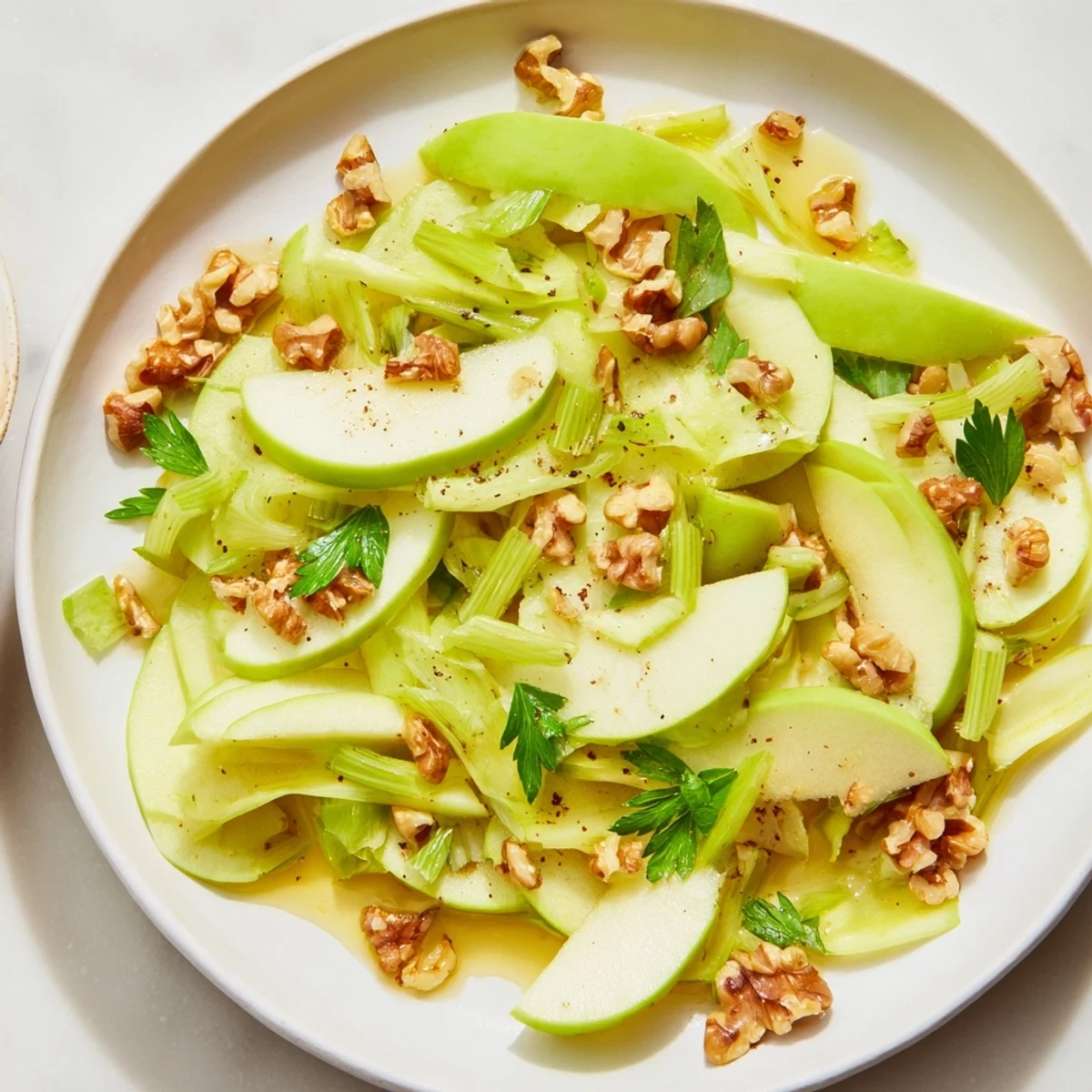 Close-up on the crunchy texture of this Green Apple and Celery Salad with Walnuts, highlighting sliced celery and golden-brown toasted nuts.