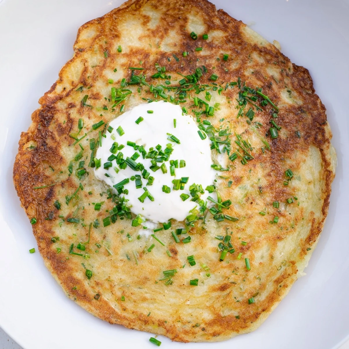 Freshly fried Irish Boxty with Sour Cream served alongside smoked salmon for a hearty St. Patrick's Day brunch.