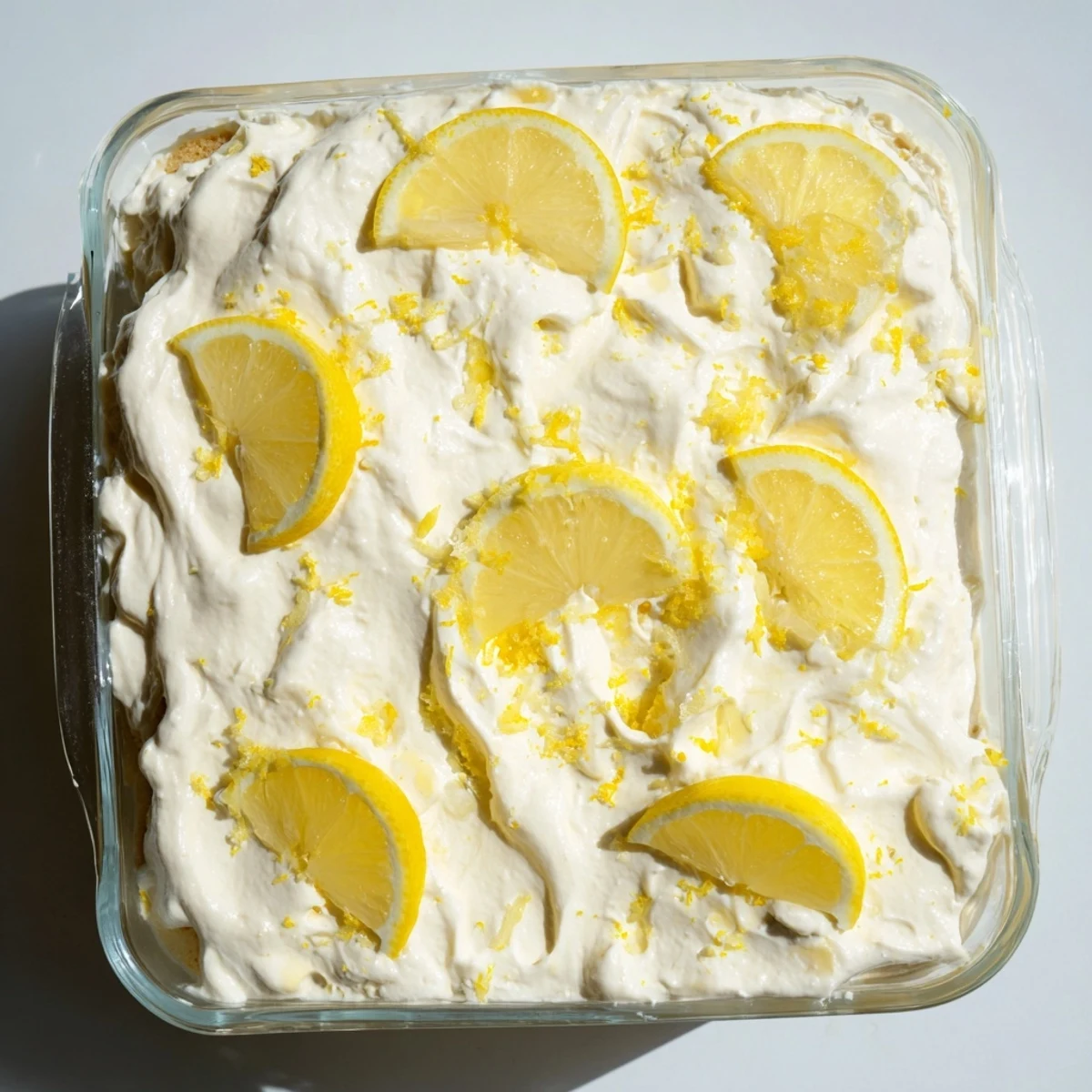 A delicious slice of the Easy Lemon Tiramisu No Bake Dessert topped with fresh lemon slices, ideal for a light treat.