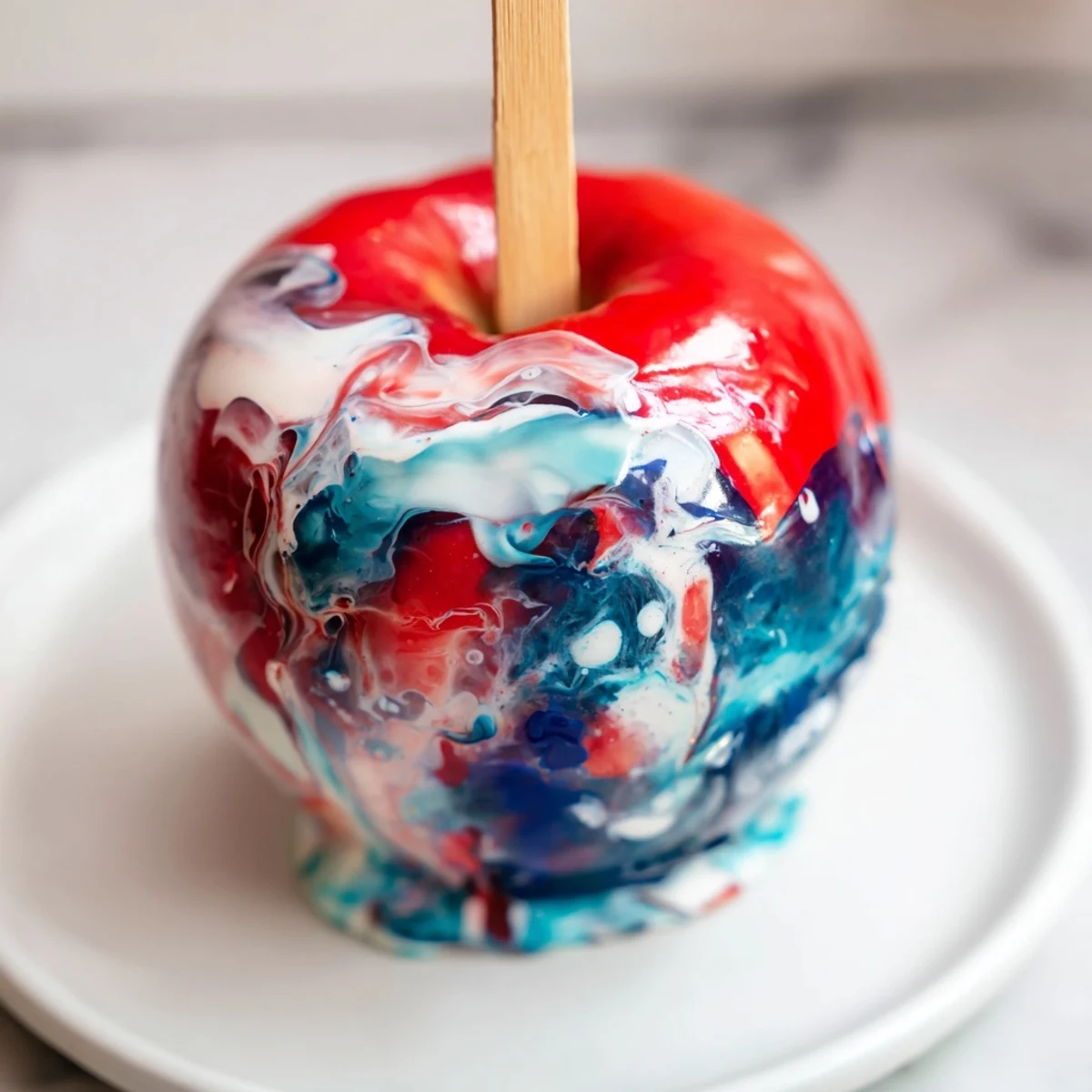 Overhead view of Marbled Effect Candy Apples arranged on parchment paper, showing the colorful marbled texture and a party-ready dessert presentation.