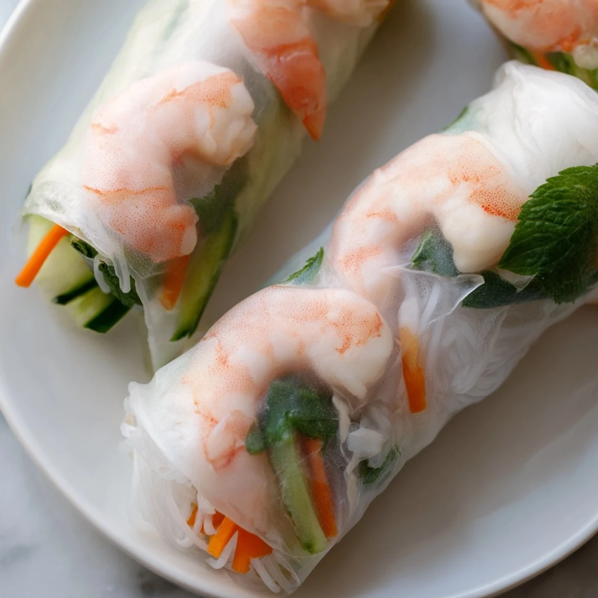Delicate Vietnamese Spring Rolls featuring shrimp, crisp lettuce, and julienned vegetables.