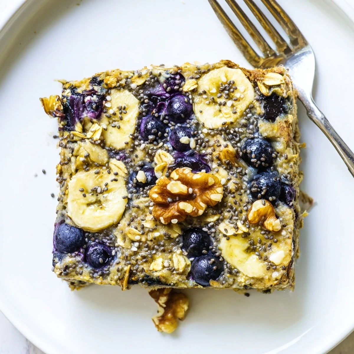 The High Protein Banana Blueberry Breakfast Bake shows a golden top and fresh banana slices.