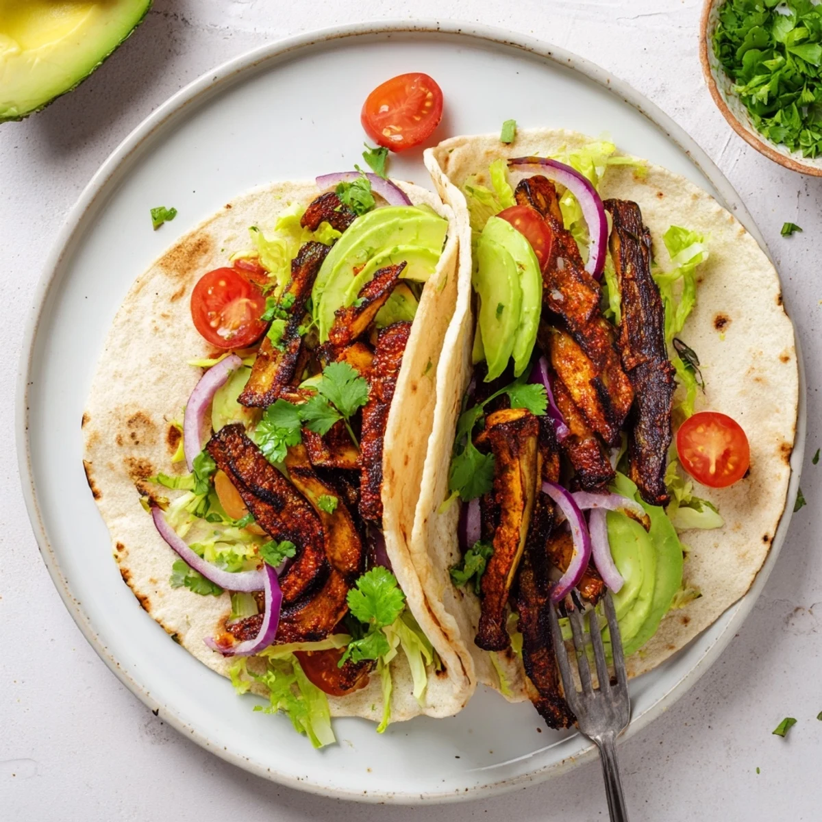 Warm corn tortillas hold smoky eggplant and vibrant veggies for these charred eggplant tacos.