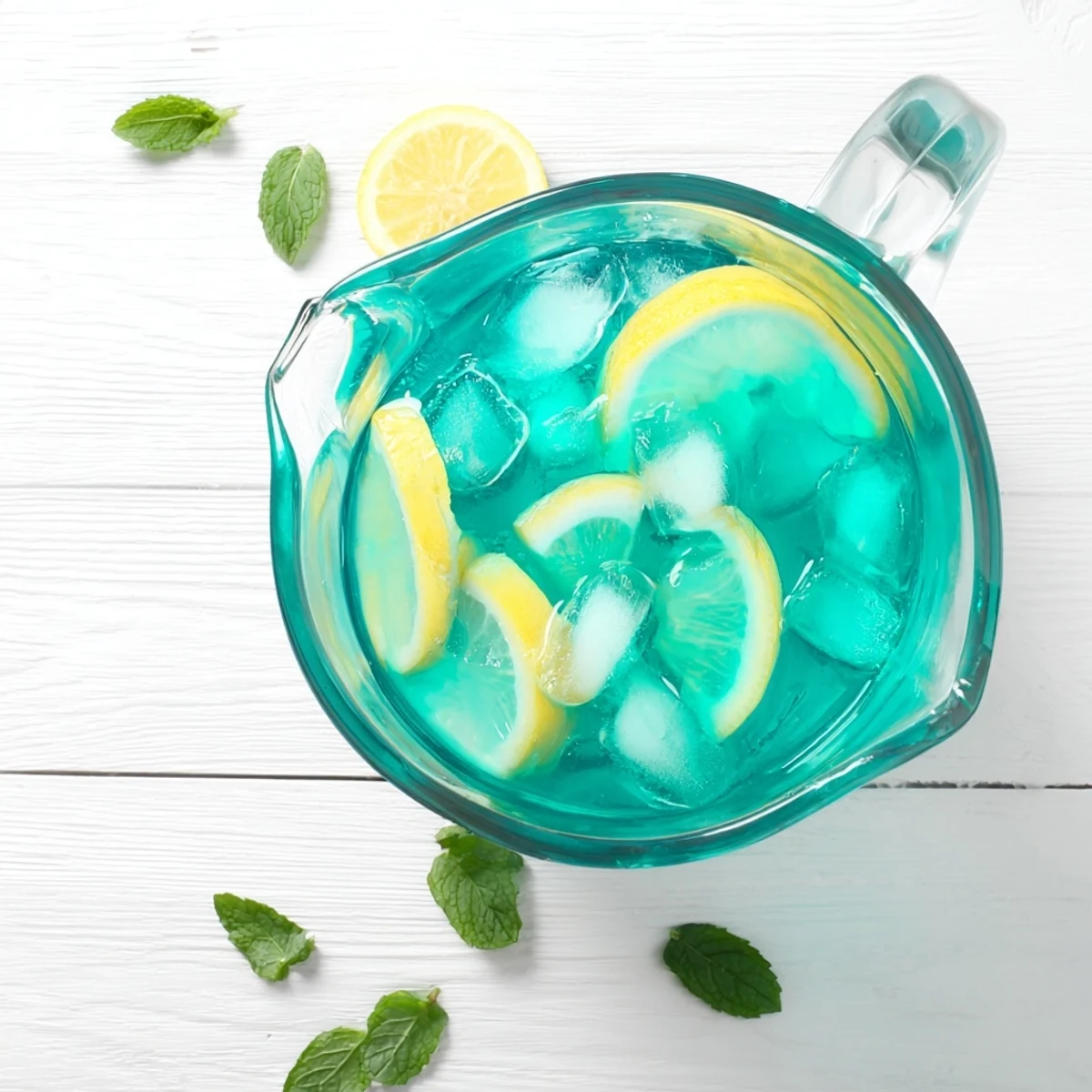 Refreshing Blue Spirulina Lemonade served over ice with a splash of zesty lemon flavor.