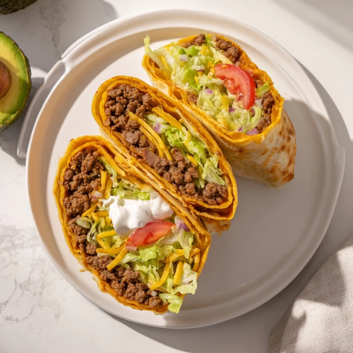 Homemade keto crunchwrap sizzling in skillet with bubbly cheese center and colorful vegetable toppings visible