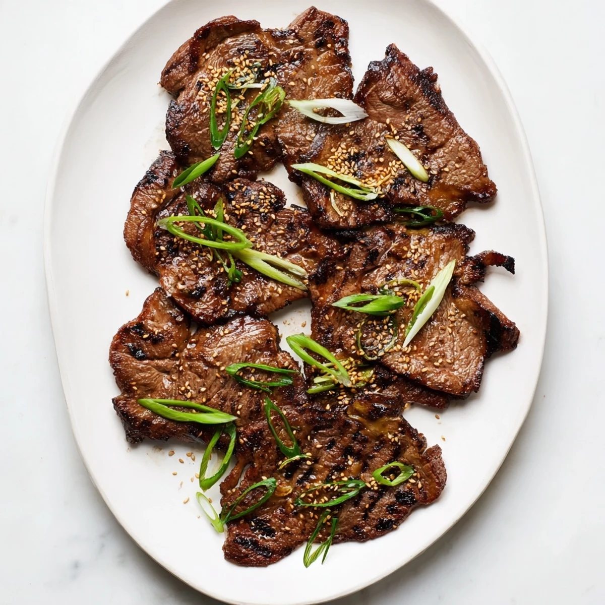 Tender beef short ribs glazed in sweet soy marinade with fresh green onion sprinkles
