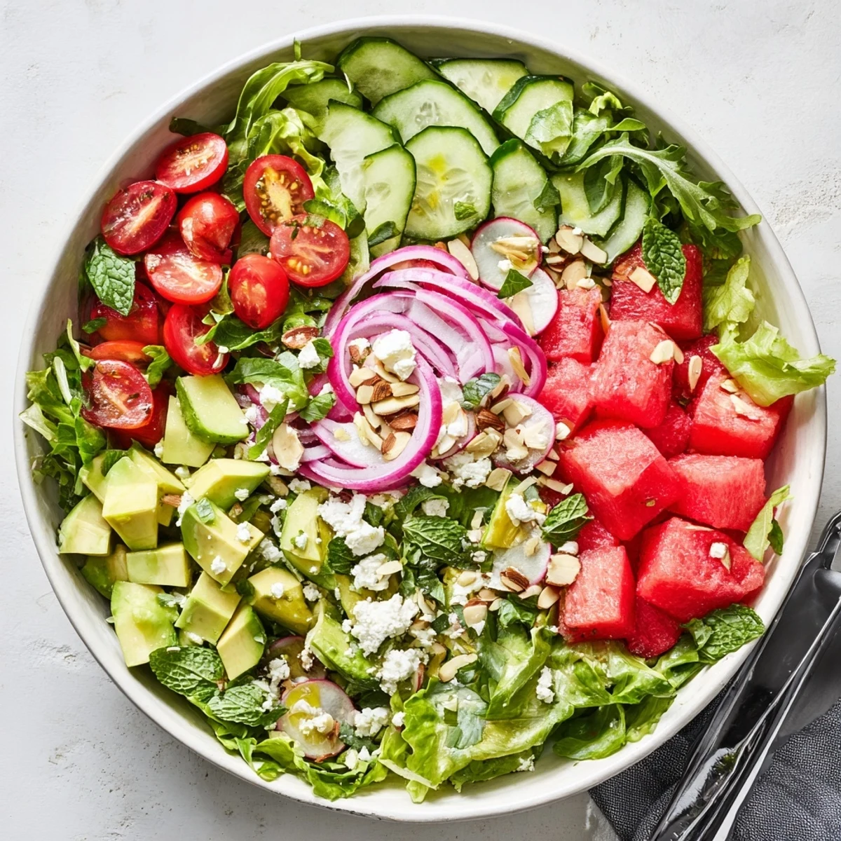 Fresh Ultimate Summer Salad featuring mixed greens, cherry tomatoes, avocado, and crunchy toasted almonds in a vibrant arrangement
