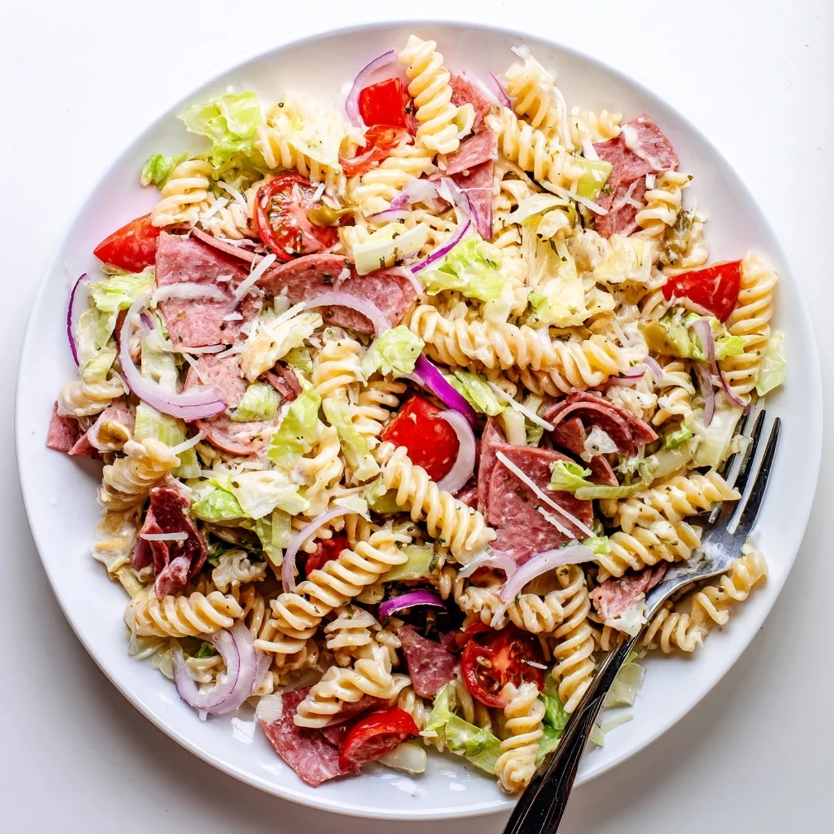 Hearty Italian-inspired grinder pasta salad tossed with crisp vegetables, cured meats, and creamy zesty dressing.
