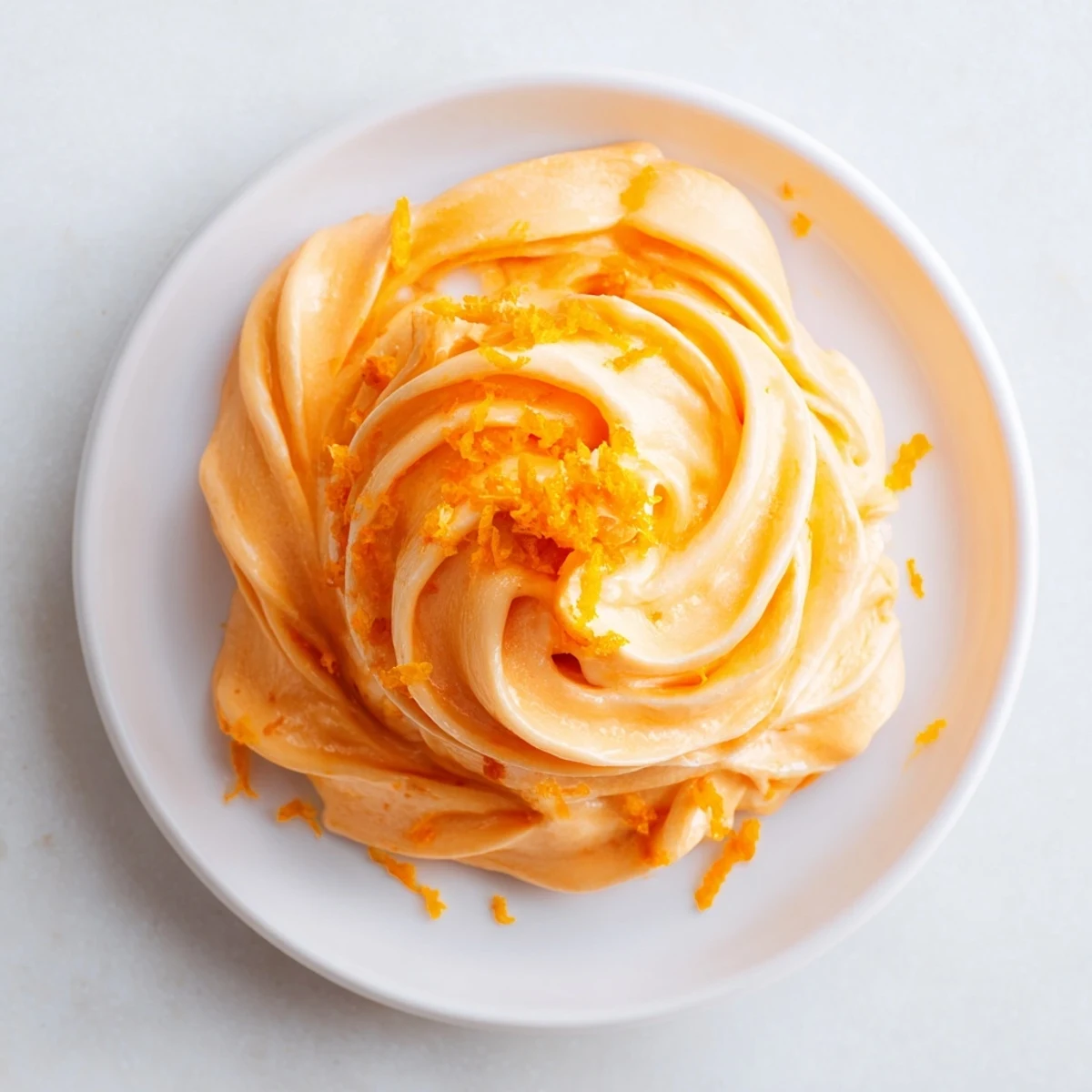 Frozen homemade orange Dole Whip dessert scooped into a waffle cone with tropical twist