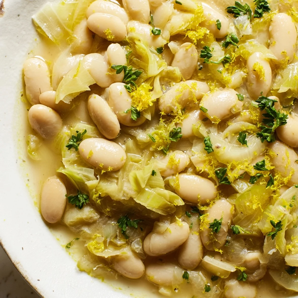 Creamy butter beans with tender leeks simmered in a skillet with fresh thyme