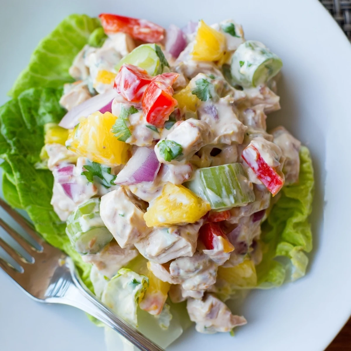Bright Hawaiian Chicken Salad Recipe served on butter lettuce, garnished with fresh cilantro
