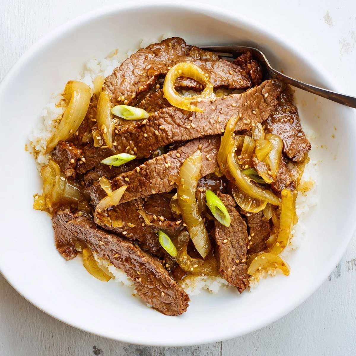 Crispy Beef and Onion Stir Fry sizzling in a wok over high heat  