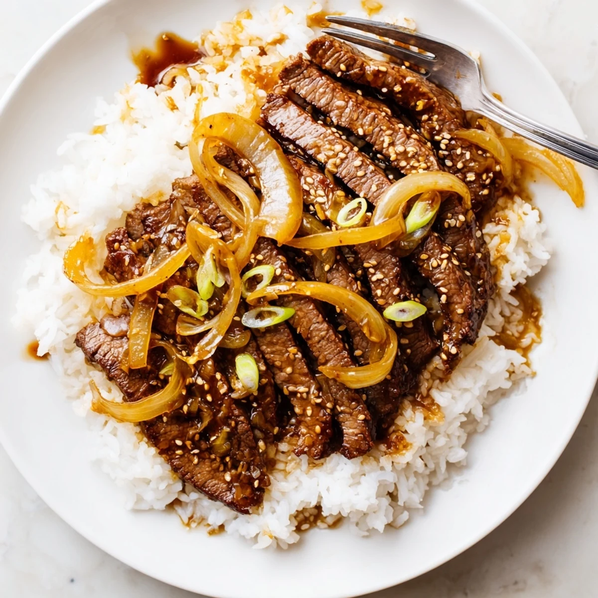 Glistening sauce coats Crispy Beef and Onion Stir Fry with caramelized onions