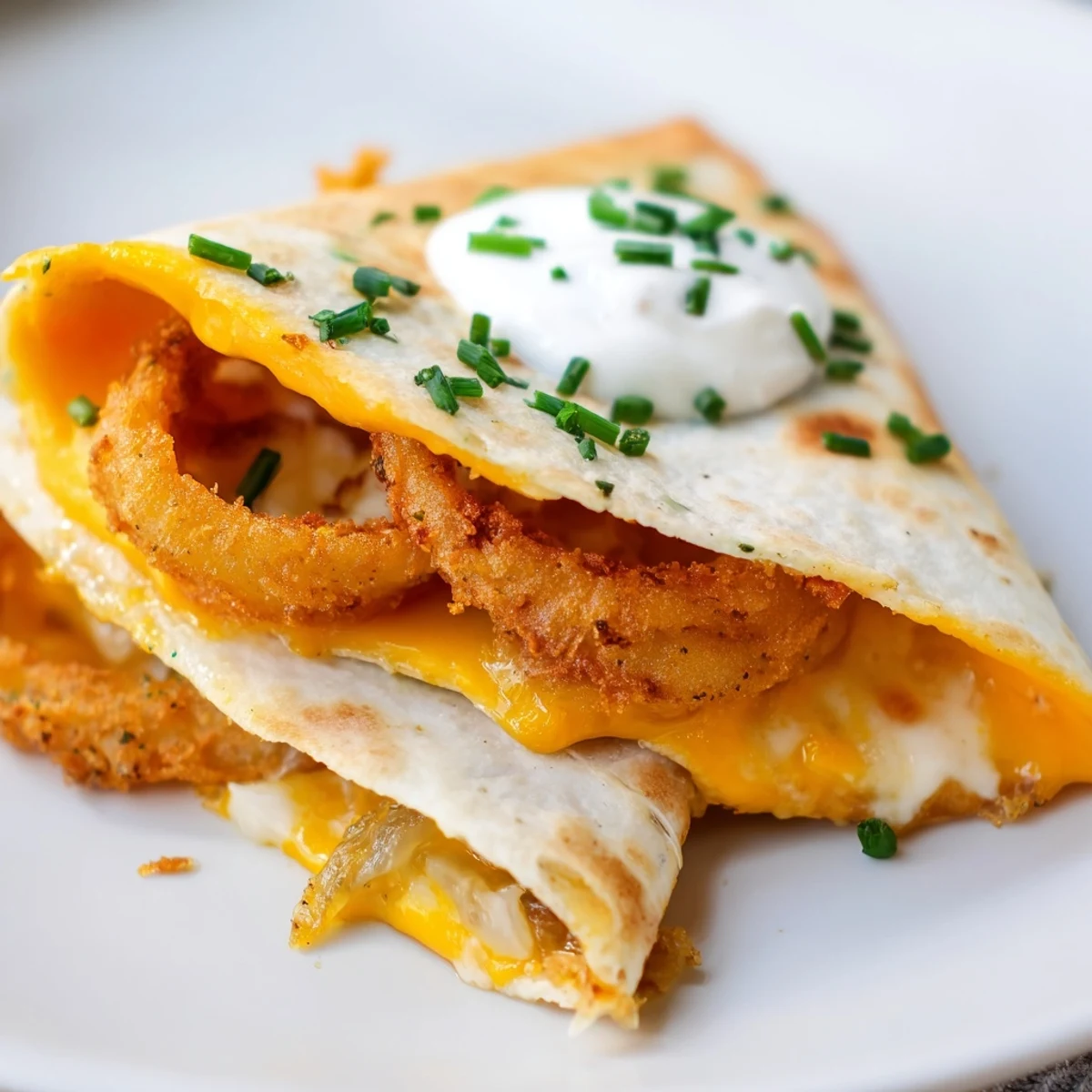 Tex-Mex quesadilla wedges topped with sour cream and served alongside fresh guacamole dip