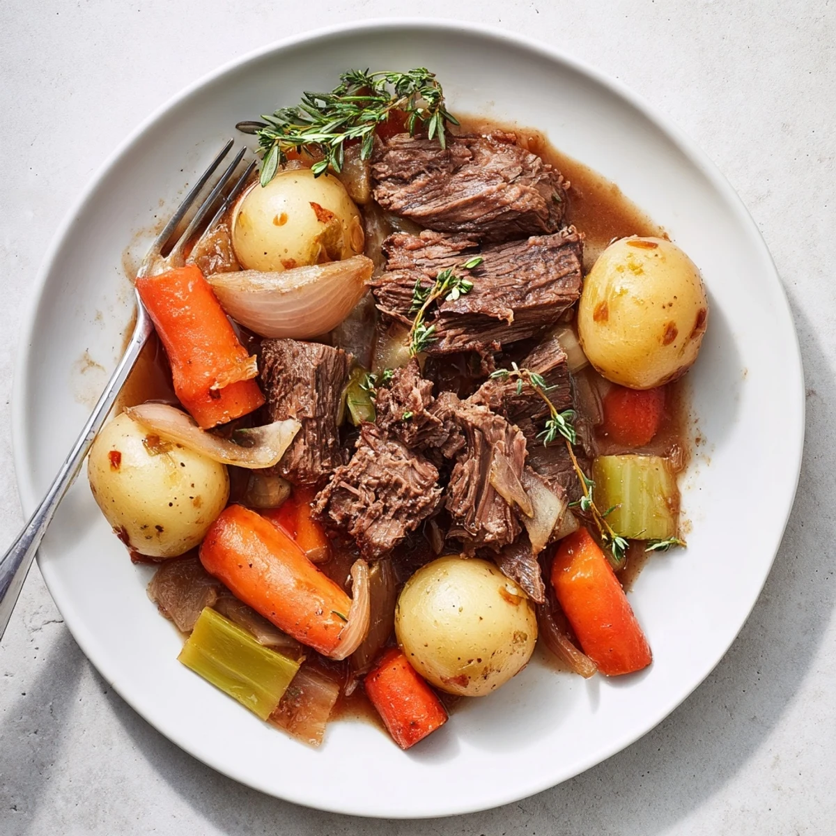 Herb braised beef chuck roast served with tender vegetables in rich savory sauce