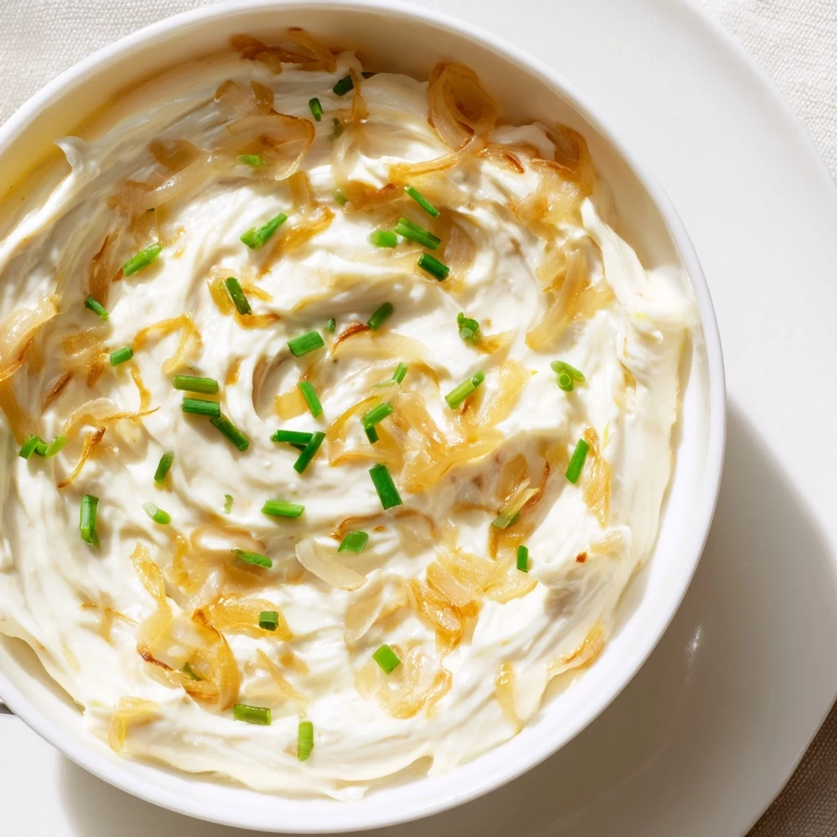 Golden brown caramelized onions folded into rich French onion dip served with crispy potato chips