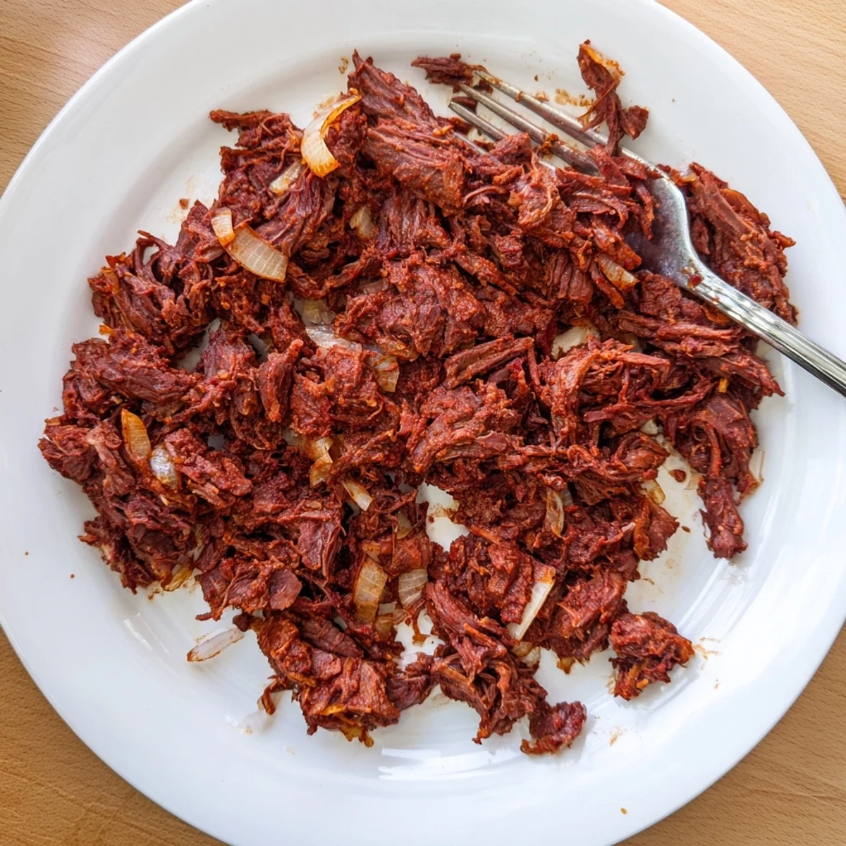 Savory Slow Cooker Beef Barbacoa piled high in a white serving bowl