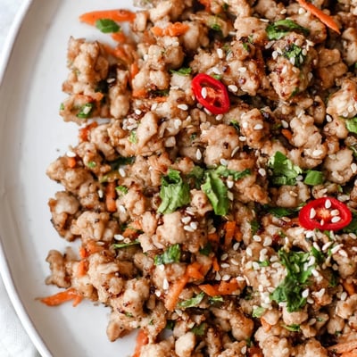 Potsticker Chicken Lettuce Boats feature juicy chicken and crunchy veggies piled into fresh lettuce cups, served with a spicy dipping sauce.